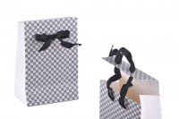 Paper gift bag in a special design and print with a 10mm grosgrain ribbon bow tie handle in size 105x67x150