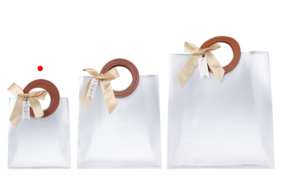 Gift bag plastic 160x80x185 mm semi transparent with bow and handle in leather texture - 12 pcs Gift bag plastic 160x80x185 mm semi transparent with bow and handle in leather texture - 12 pcs