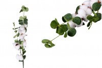 Decorative branch with cotton flowers and green leaves