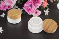 Glass jar for cream 50 ml in white color with bamboo lid and plastic seal