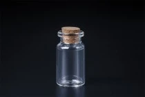 Mini clear glass bottles with cork stoppers, can be used as a wedding or christening favor