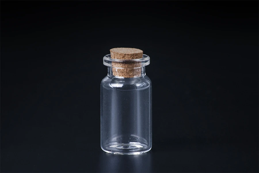 Mini clear glass bottles with cork stoppers, can be used as a wedding or christening favor
