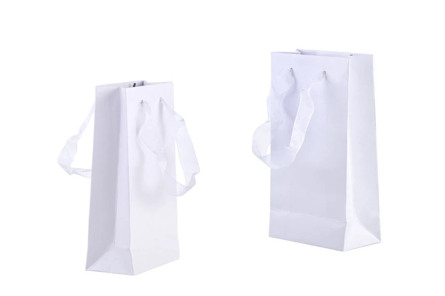 Laminated paper gift bag with a 2 cm sheer organza ribbon handle in different colour shades Laminated paper gift bag with a 2 cm sheer organza ribbon handle in different colour shades