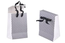 Paper gift bag in a special design and print with a 10mm grosgrain ribbon bow tie handle in size 105x67x150 Paper gift bag in a special design and print with a 10mm grosgrain ribbon bow tie handle in size 105x67x150