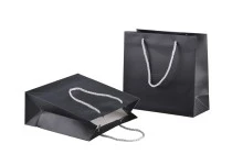 Black laminated gift bag with silver twisted rope handle in size 220x90x210 Black laminated gift bag with silver twisted rope handle in size 220x90x210
