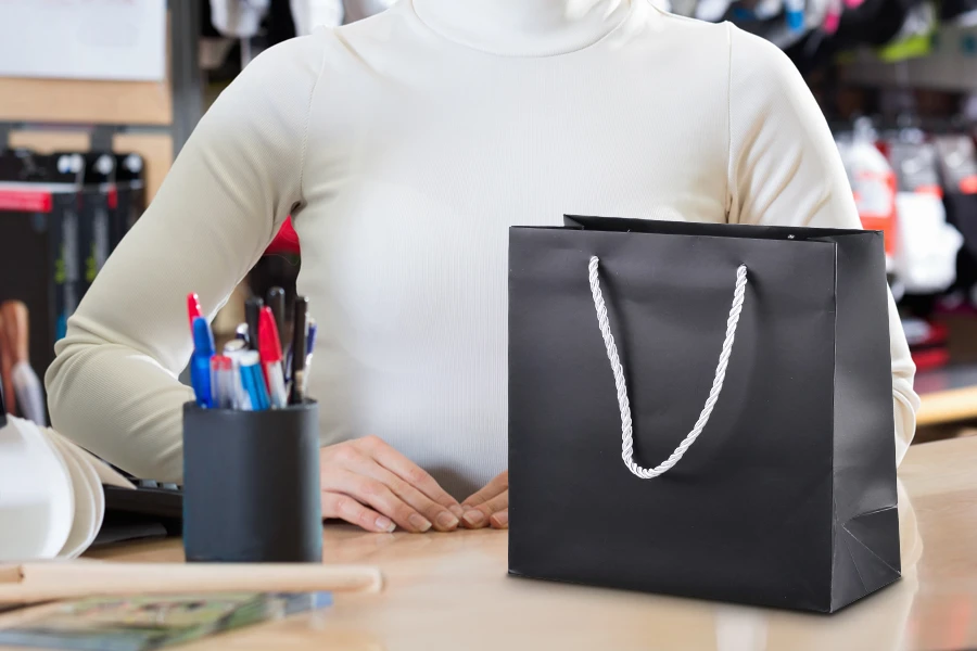 Black laminated gift bag with silver twisted rope handle in size 220x90x210 Black laminated gift bag with silver twisted rope handle in size 220x90x210