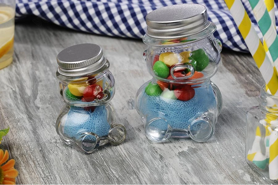 Petit pot pour des faveurs de 30ml en verre et en forme de nounours avec couvercle en aluminium argenté Petit pot pour des faveurs de 30ml en verre et en forme de nounours avec couvercle en aluminium argenté-