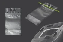 Doypack stand-up pouch packaging 350 ml transparent with zipper and holes for a drinking straw and carrying around Doypack stand-up pouch packaging 350 ml transparent with zipper and holes for a drinking straw and carrying around