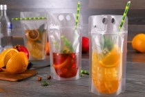 Doypack stand-up pouch packaging 350 ml transparent with zipper and holes for a drinking straw and carrying around Doypack stand-up pouch packaging 350 ml transparent with zipper and holes for a drinking straw and carrying around