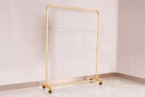Metal floor stand 120x40x135 cm in gold color with wheels for hangers Metal floor stand 120x40x135 cm in gold color with wheels for hangers