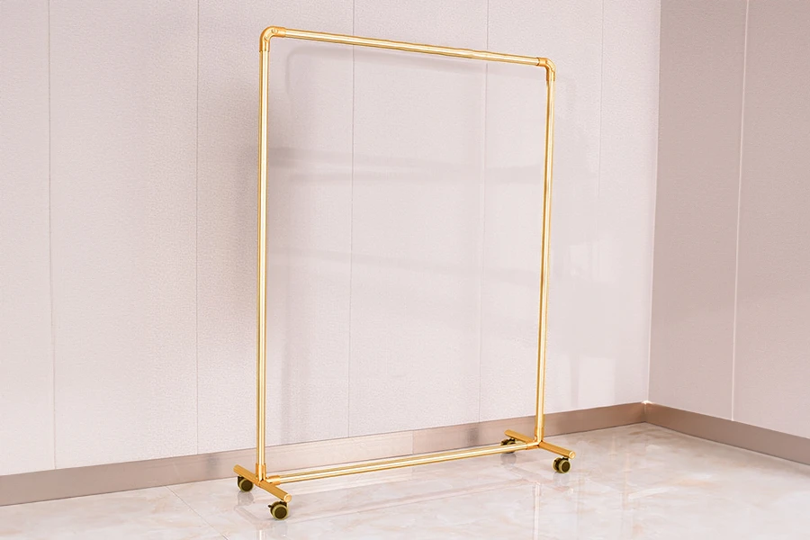 Metal floor stand 120x40x135 cm in gold color with wheels for hangers Metal floor stand 120x40x135 cm in gold color with wheels for hangers