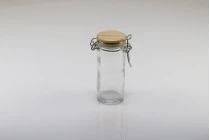 Barattolo tondo in vetro da 90 ml da 108x45 mm con tappo in legno e chiusura ermetica (filo e gomma sul tappo) Barattolo tondo in vetro da 90 ml da 108x45 mm con tappo in legno e chiusura ermetica (filo e gomma sul tappo)